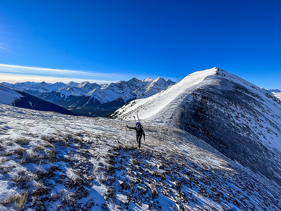 Bootpacking up the last of the skiable terrain.