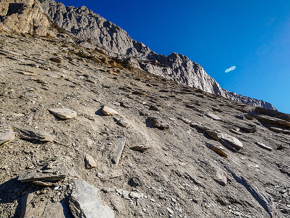 The SE traverse and break to the south ridge visible high above to the right under the summit cliff.
