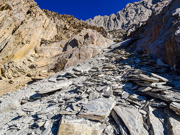 Ascending to the traverse under summit cliffs.