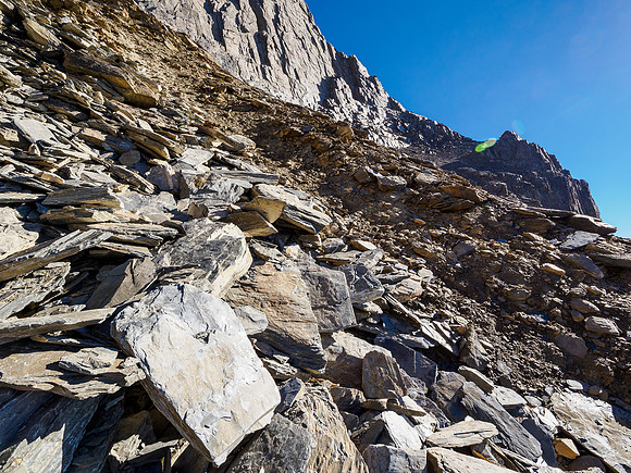 Traversing the obvious rubble ledge to the break at upper right.