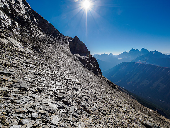 Traversing the obvious rubble ledge to the break at center.