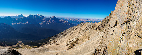Views off the SSE ridge down the SW face to the avalanche paths below, summit cliffs at right.