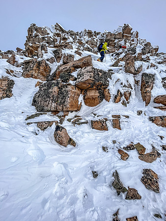 Ascending the crux outcrop on the south ridge.