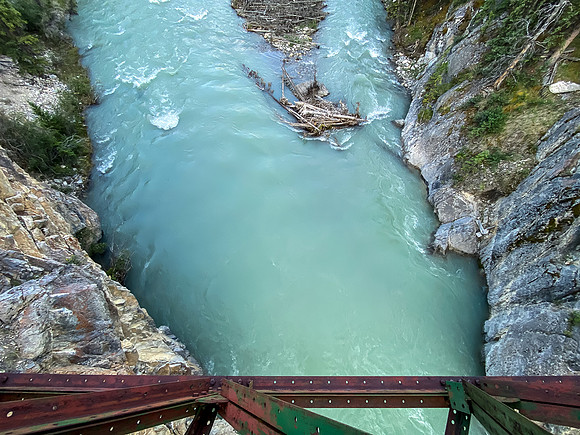 The Red Deer River flows under an old bridge along the Cascade fire road.