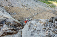Scrambling up slabs and scree on the east face of Tyrrell.