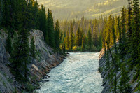 The Red Deer River flows under an old bridge along the Cascade fire road.