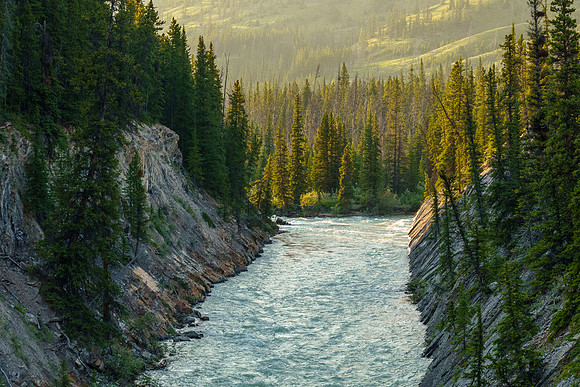 The Red Deer River flows under an old bridge along the Cascade fire road.