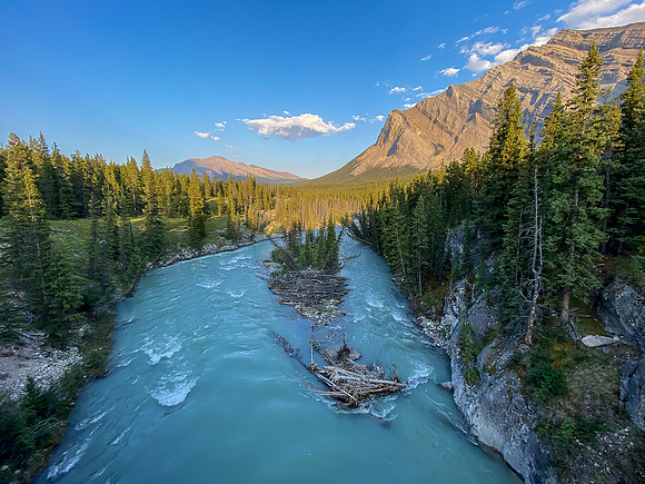 The Red Deer River flows under an old bridge along the Cascade fire road.