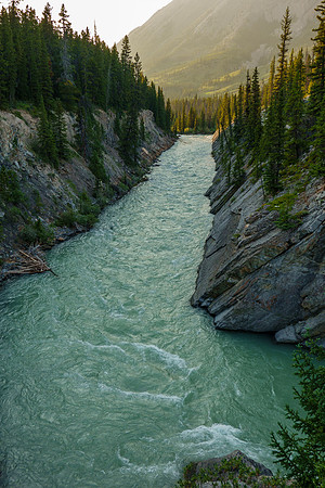 The Red Deer River flows under an old bridge along the Cascade fire road.