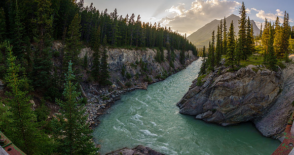 The Red Deer River flows under an old bridge along the Cascade fire road.