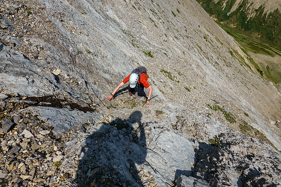 Scrambling up slabs and scree on the east face of Tyrrell.