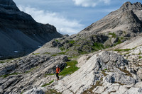 Phil exits via the high line traverse in this view back to the col.