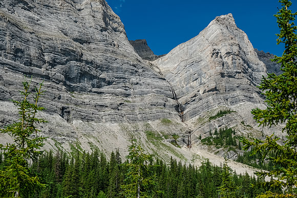A huge waterfall comes down from a hidden upper bowl far up the access creek. Unclimbed ice route?