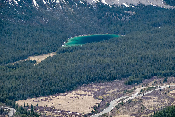An unnamed tarn glistens along the Clearwater River valley.