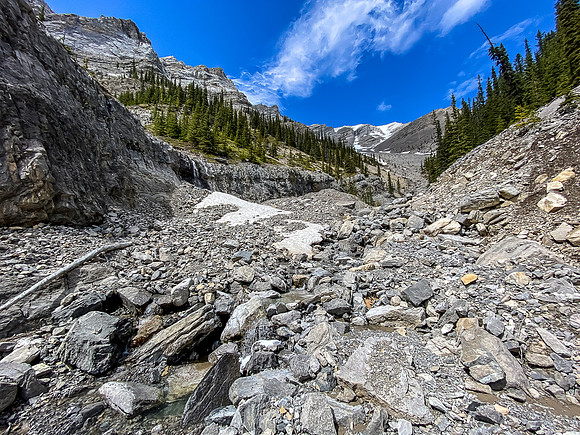 Approaching the upper south drainage where our route deviates east (R).
