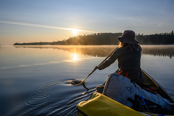 Paddling a calm Otter Lake along the Churchill River.