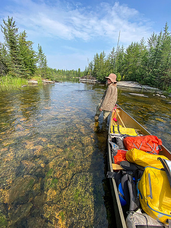 Navigating a rock garden along the Drinking River at the outlet of Soroski Lake.