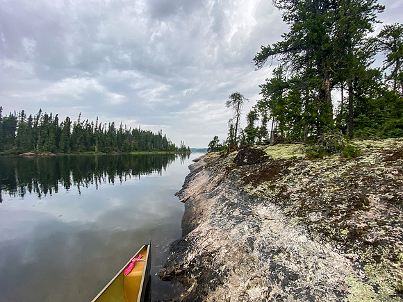 Leaving the submarine island site on Wapassini Lake in light rain.