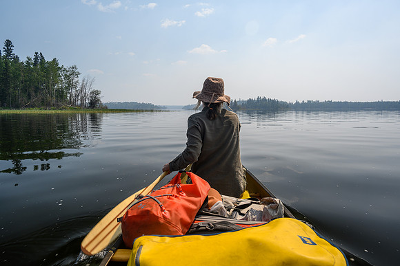 Paddling through Cow Narrows on Mountain Lake along the Churchill River.