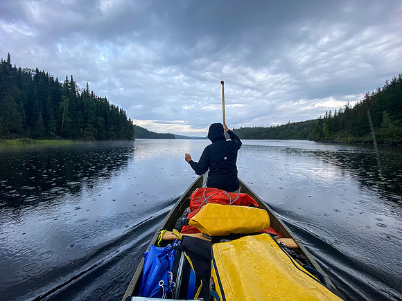 Leaving the submarine island site on Wapassini Lake in light rain.
