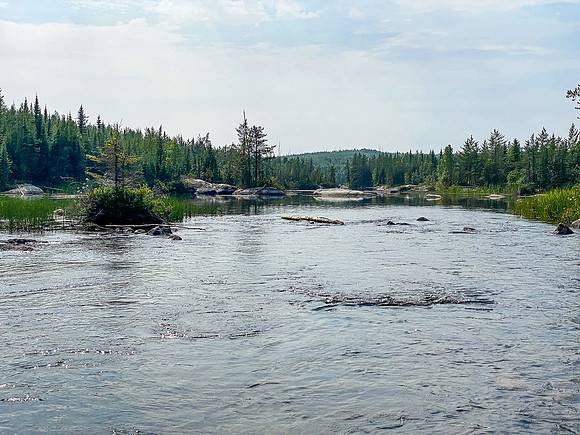 Navigating a rock garden along the Drinking River at the outlet of Soroski Lake.