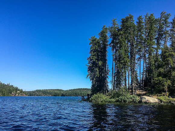 Another bluebird day on the final morning of our trip as Bill and Harold leave camp on Onnie Lake.