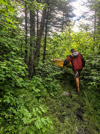 Jon and Dylan go old school on one of the 250m portages out of Glenn towards Optic Lake.