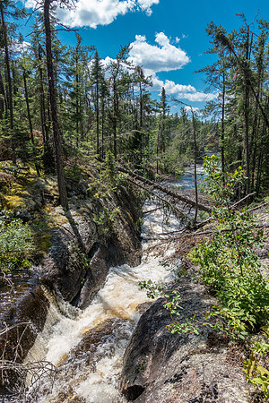 This channel is normally nearly empty in the summer and the trail crosses it on a ledge just above this shot.