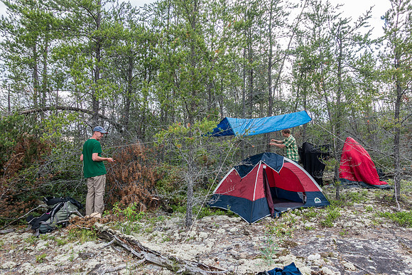 Rod and Tim try to waterproof their tiny tent after getting a bit wet in the rain on the first night.