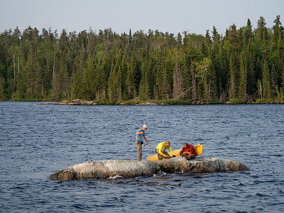 Cleaning the walleye on a small rock across from camp - never clean fish in your camp!