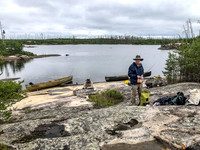 Rod with his trusty bag of Reese's Pieces and Hentie filleting Walleye in the background.