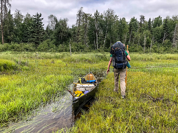 It was much easier to simply walk beside the boat on the floating bog, rather than mess around with the shallow "stream"