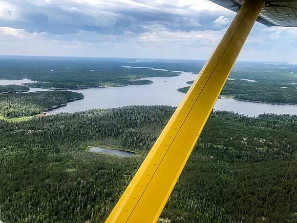 A fire is seen smoldering off in the distance near Hammerhead Lake, the large lake visible here is the lovely Rostoul Lake - another closed lake that we were originally going to paddle through.