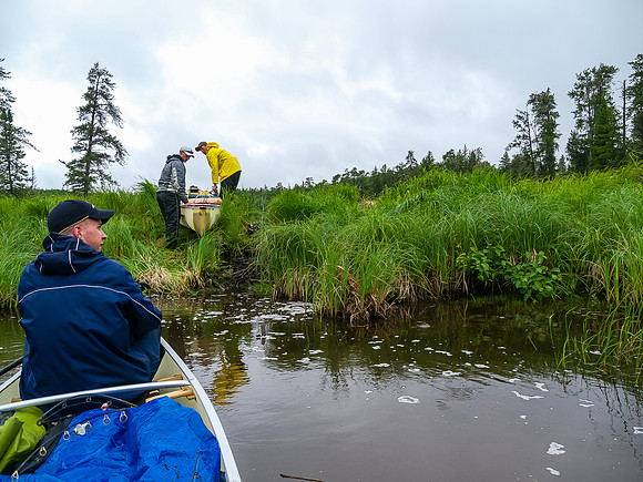 Greg and Clarence 'bull' their canoe over a stubborn beaver dam on our way to Dragon Lake.