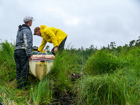 Greg and Clarence 'bull' their canoe over a stubborn beaver dam on our way to Dragon Lake.