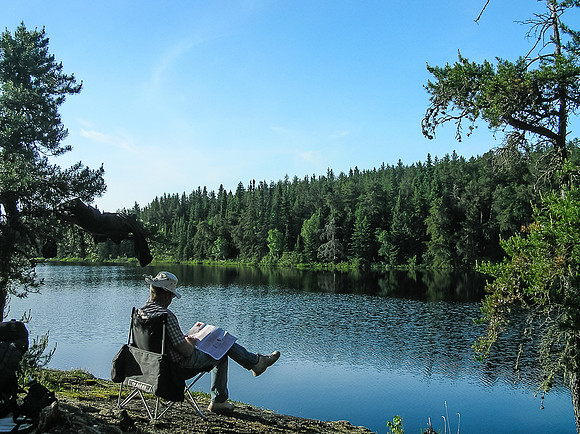 Ron relaxes with a magazine at our Haggart Lake camp.