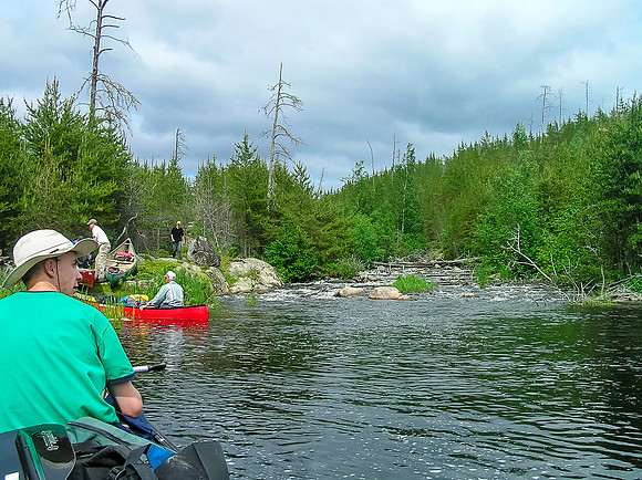 Note the t-shirts and clearing skies!! YES! Coming up to another portage on the Garner River.