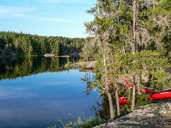 A very calm lake for fishing after supper.
