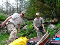 Harold steps into the canoe after another portage.