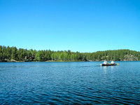 We paddle past cabins (L).