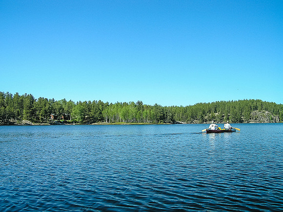 We paddle past cabins (L).