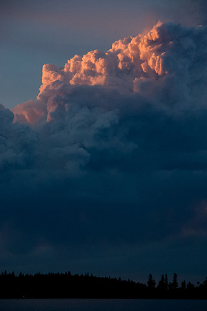 The smoke looks volcanic with the setting sun.