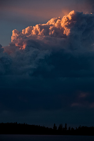 The smoke looks volcanic with the setting sun.