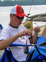 Eric fixes fishing gear at camp on Thursday morning on Chase Lake.