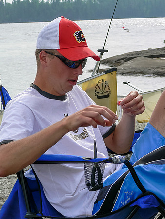 Eric fixes fishing gear at camp on Thursday morning on Chase Lake.