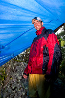 Huddled under a tarp.