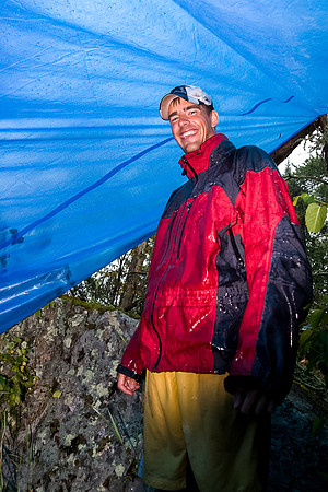 Huddled under a tarp.