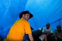 Huddled under a tarp.