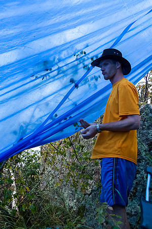 Huddled under a tarp.
