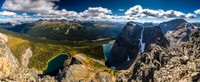 Greater and Middle Pharaoh Peaks rise dramatically over their namesake lake. Peaks such as Pilot, Brett, Black Brett and Bourgeau at distant left and center.